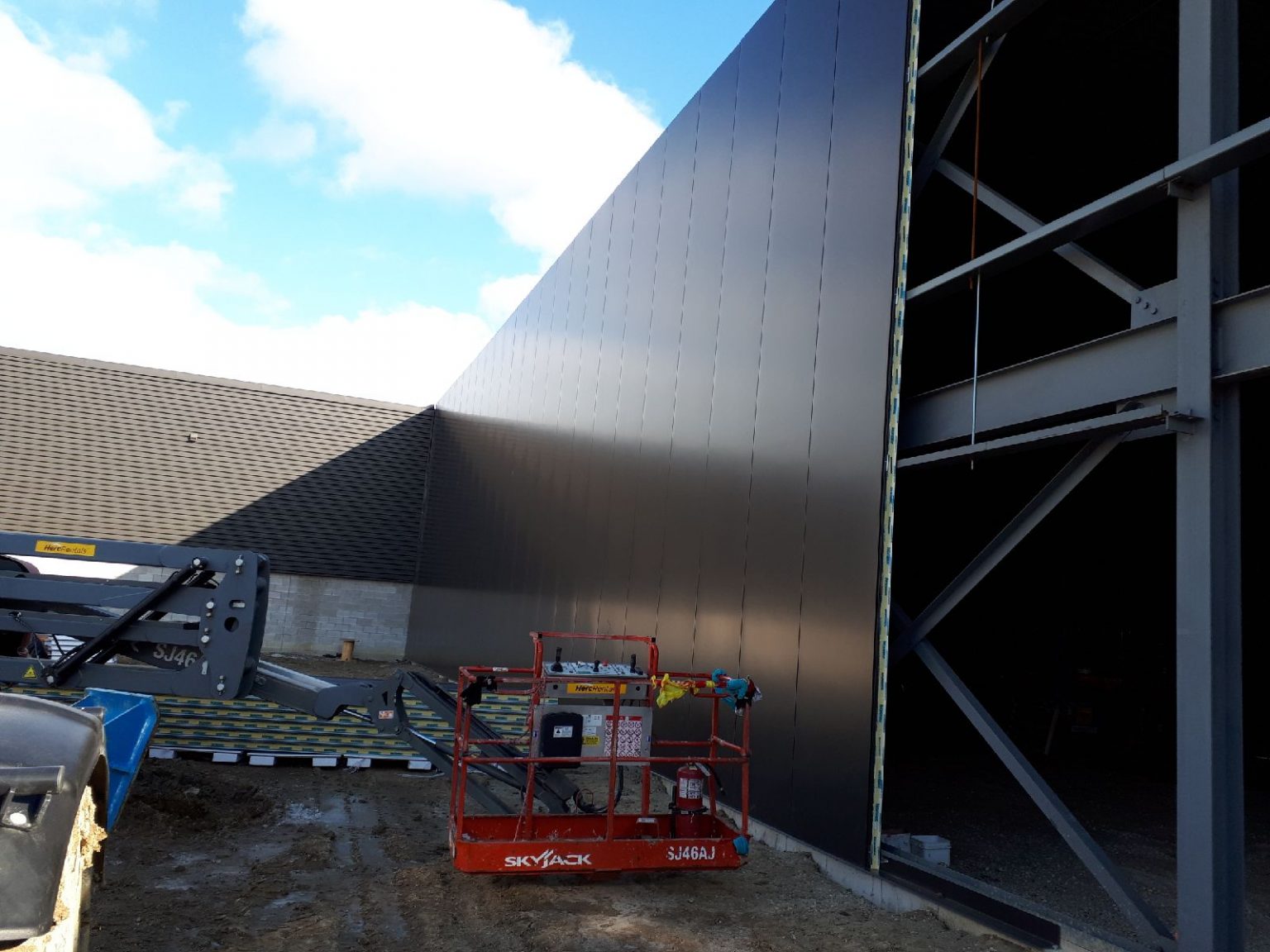 a picture of a construction site with a building being assembled with Structural Panels Isowall panels