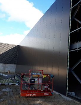 a picture of a construction site with a building being assembled with Structural Panels Isowall panels