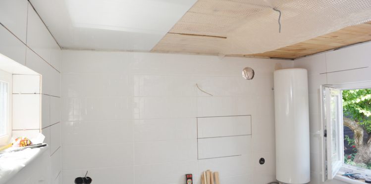 Installing white PVC Ceiling Boards in the new bathroom
