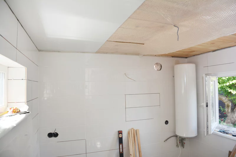 Installing white PVC Ceiling Boards in the new bathroom